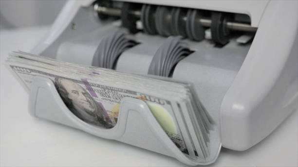 istock Side View of Machine Counting Money 2148478058