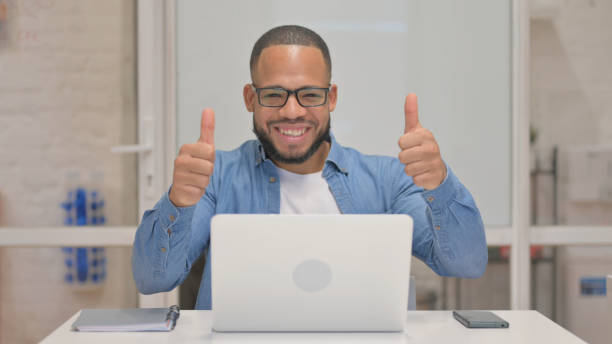 istock Thumbs Up by Mixed Race Man Using Laptop 2148478225