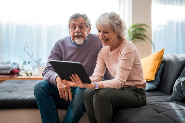 istock Senior Couple Engaged with Digital Tablet Indoors 2148478358