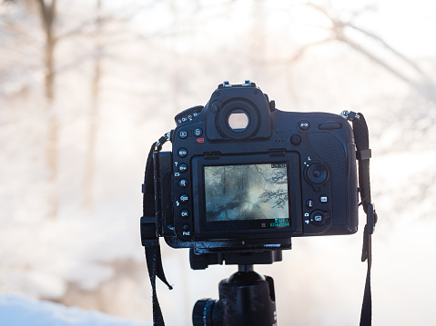 A camera is mounted securely on a tripod, ready to capture stable and clear images. The tripod ensures stability and precision during photography sessions.