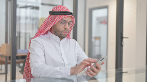 istock Young Arab Man Text Messaging on Smartphone 2148479991