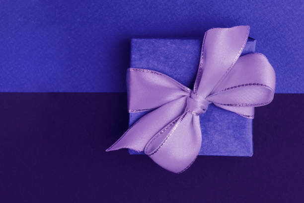 istock Blue gift box with a purple bow on a two-tone background, blue and purple. 2148480151