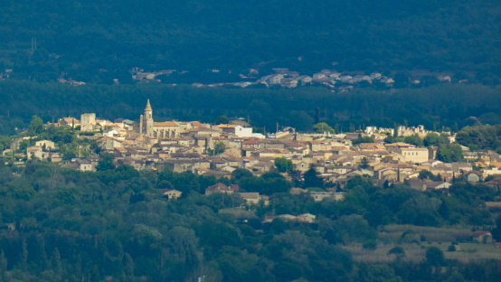 Overall photo of a picturesque provencal village in the Luberon nestled in the middle of the hills. This photograph was taken in Provence in France.