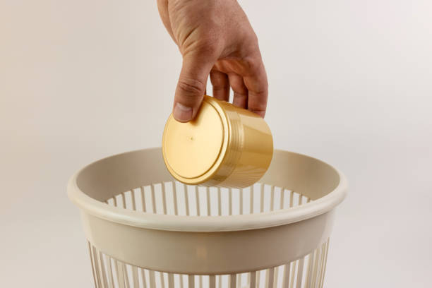 Waste Management Concept. Golden Trash Bin With Wheels On White Background. 3d Rendering