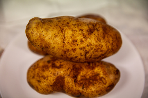 Three Russet Potatoes ready to be baked