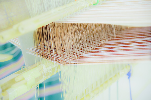 Cotton fibers on a local loom at Nan Province, Thailand. Local textile work of the northern region in Thailand.