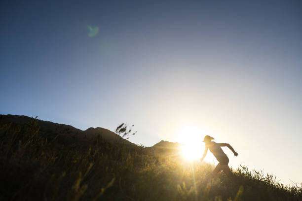 istock Silhouette Female trail runner running uphill in mountains at sunset 2148481168