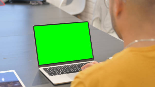 istock Hispanic Man Working on Laptop with Green Screen 2148481998