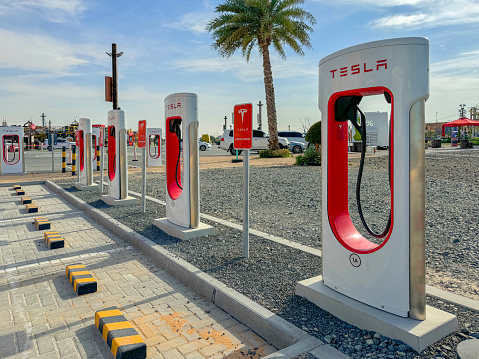 Dubai, United Arab Emirates - March 2, 2024: Tesla Supercharger Station on the route from Dubai to Abu Dhabi. High quality photo