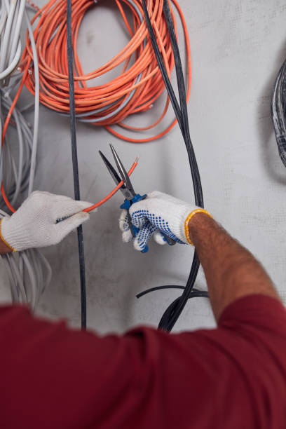 electrician working on a wire system on a construction site. - electricity chaos cable connection стоковые фото и изображения