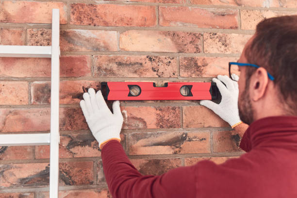 istock Handyman with spirit level working in a new home interior. 2148484421