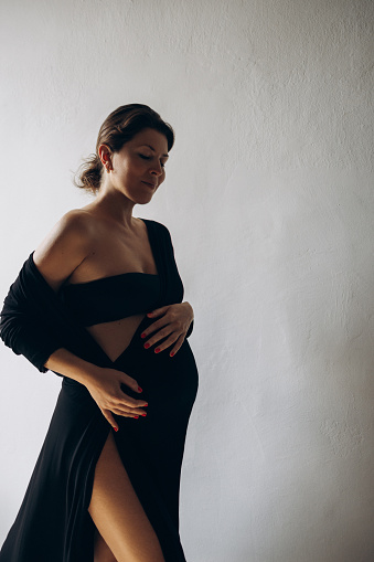 Beautiful pregnant girl in a black dress