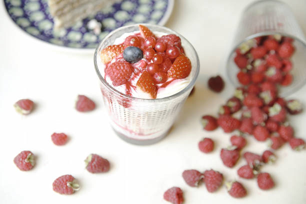 A mouth-watering piece of cake sitting on a plate next to a variety of fresh berries.