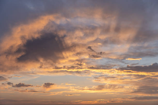 istock The evening sky, painted with strokes of orange and gray, provides a mesmerizing backdrop, perfect for creative projects requiring a touch of natural elegance 2148486359
