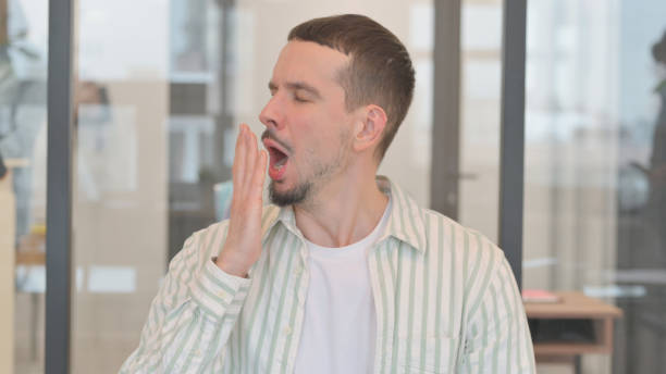 istock Portrait of Yawning Tired Creative Young Man 2148486391
