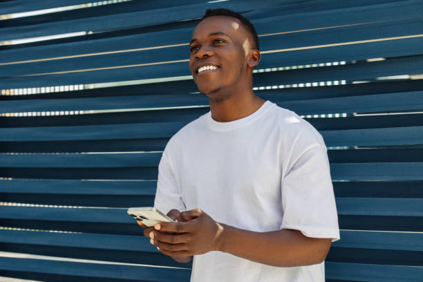 istock Ecstatic young man using trendy smartphone, smiling joyfully, millennial guy enjoy new mobile application 2148486509