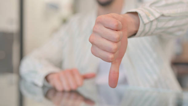 istock Close of Thumbs Down by Man in Office 2148486532