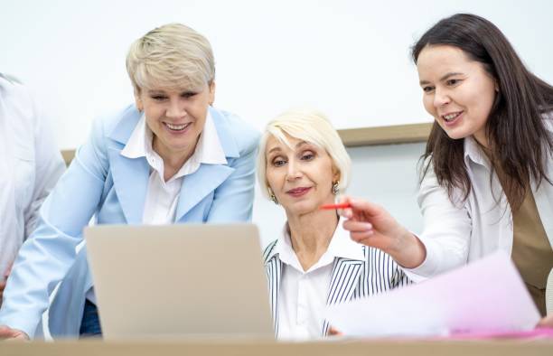 istock Three businesswomen discussing project using laptop in modern office 2148487703