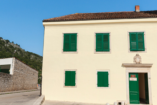 Hvar Croatia - May 27 2011; Regular pattern of green windows and door in exterior wall of museum building
