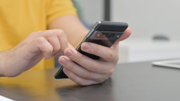 istock Close of Male Hands Using Phone 2148489165