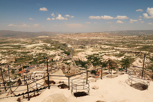 View from the Caslte, Kalesi of Uchisar onto the landscape that surrounds it, with its rock, cave structure in the foreground, Uchisar, Cappadocia, Turkey 2022