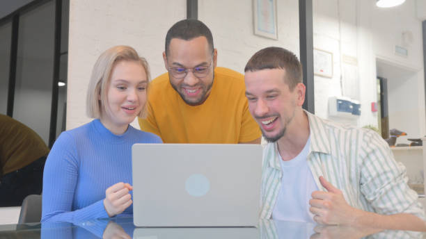 istock Excited Creative Mixed Race People Celebrating Success on Laptop 2148492481