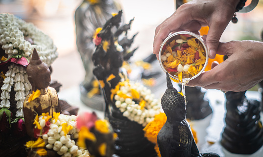 Songkran traditions in Thailand Thai Buddhists often take out Buddha statues in their homes and bathe them with Thai perfume and flowers on the first day of Songkran Festival.