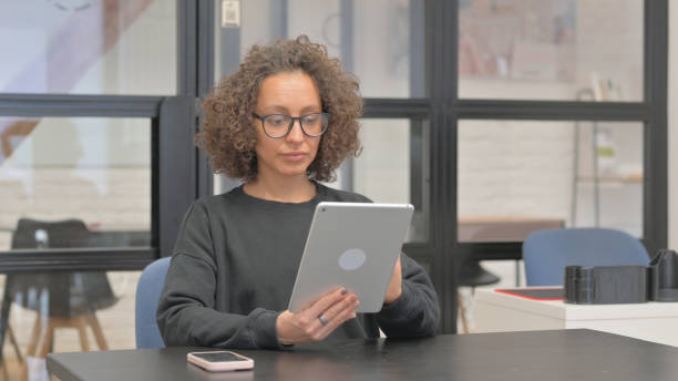 istock Mixed Race Woman Working on Digital Tablet 2148494263