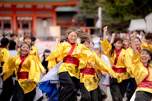 Kyoto, Japan - March 31 2024 : Kyoto Sakura Yosakoi ( Sakuyosa ) festival. A group of dancers dancing down a street at the Okazaki area around Heian Shrine.
