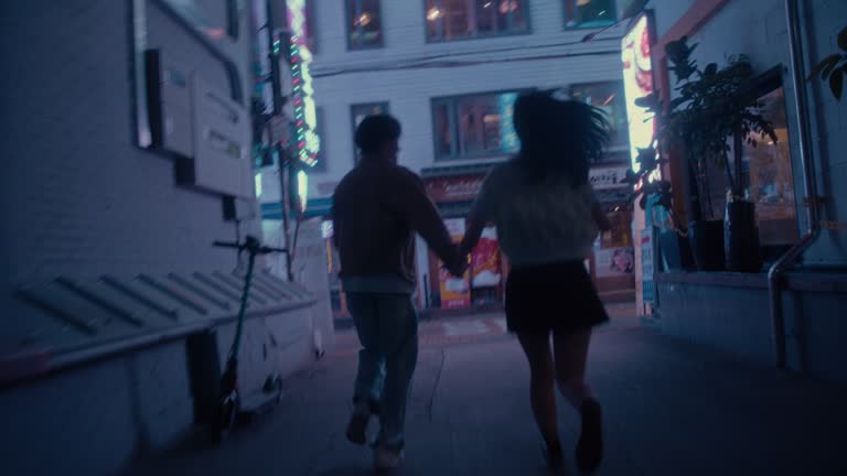 Boyfriend and Girlfriend running in an alley