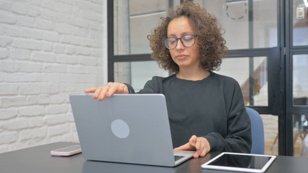 istock Hispanic Woman Leaving Office after Working on Laptop 2148497537