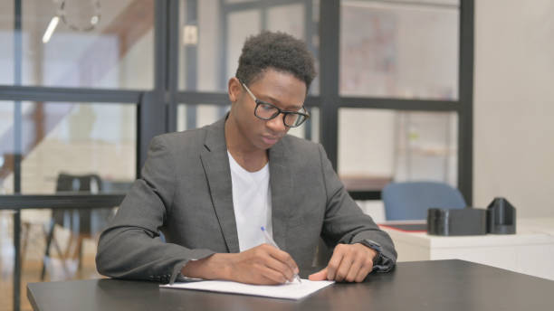 istock African American Man Writing a Letter in Office 2148497584