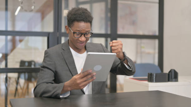 istock Online Success on Digital Tablet by African American Man 2148498455