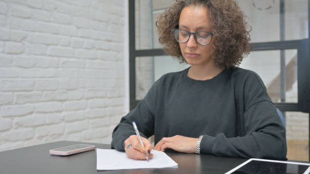 istock Close up of Female Hand Writing a Letter 2148498535