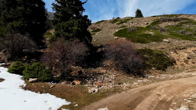 Dangerous part of winding road covered with melting snow
