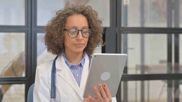 istock Portrait of Hispanic Female Doctor Using Digital Tablet 2148499477