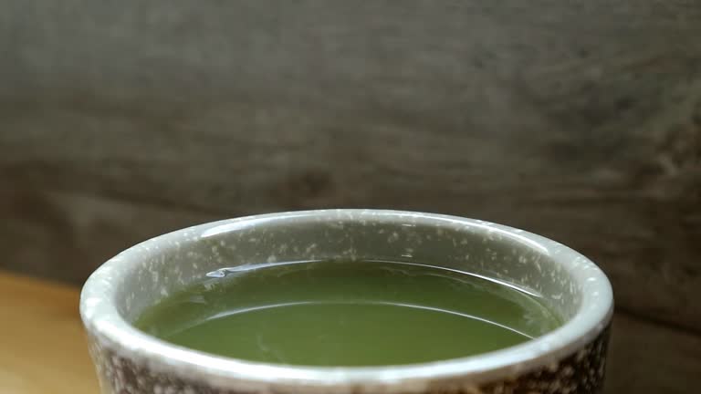 Closeup of a Cup of Hot Japanese Matcha Green Tea with Smoke Footage