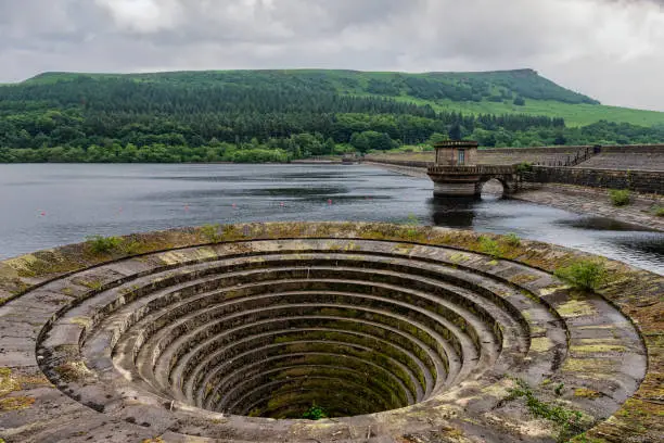 Ladywell reservoir and the overflow drain, nicknamed the plughole. Derwent edge can be seen in the distance. Located in the peak district, Derbyshire, England