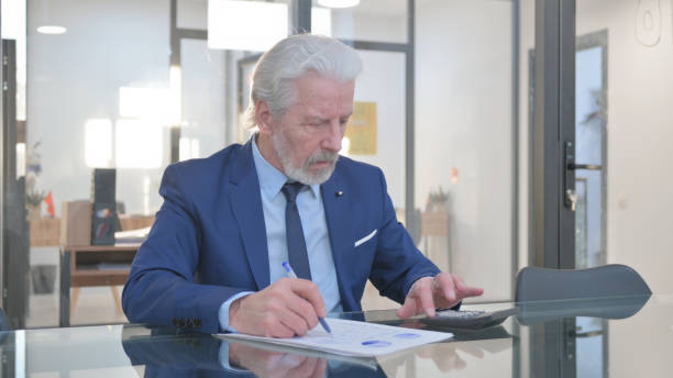istock Senior Businessman Doing Financial Calculations at Work 2148501115