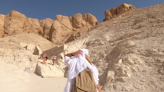4K Video of Female tourist walking to Valley of the Kings in Luxor, Egypt