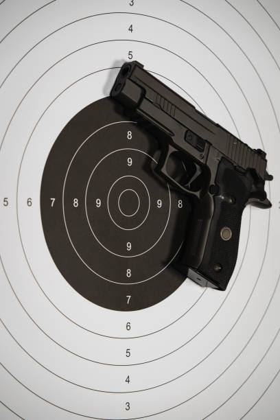 istock 9mm pistol and shooting target, vertical photo. 2148507025