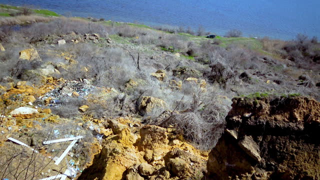 Environmental crime, illegal spontaneous garbage dump on the coastal slopes of the Khadzhibey estuary, Ukraine