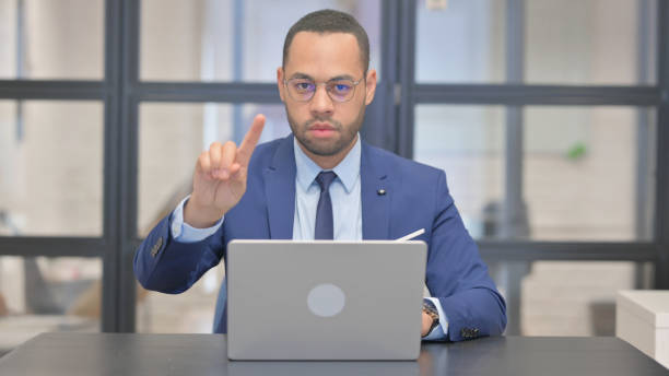 istock Mixed Race Businessman Shaking Head in Denial while Working in Office 2148510022