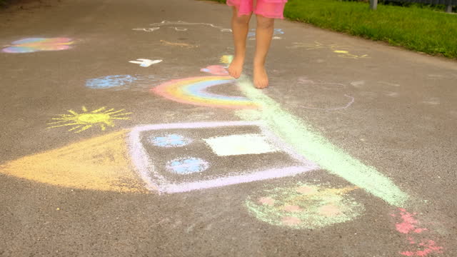 children on the street draw with chalk. selective focus. kid.