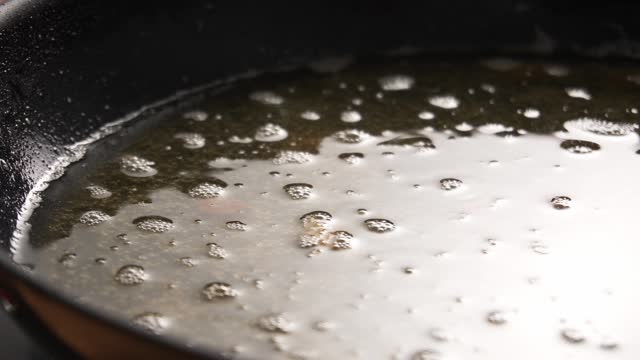 Used Cooking Oil in Frying Pan with bubbles.