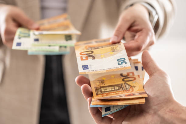 istock Businesswoman's hands exchanging euro banknotes, closeup shot. 2148510543