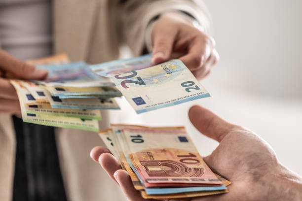 istock Businesswoman's hands exchanging euro banknotes, closeup shot. 2148510544
