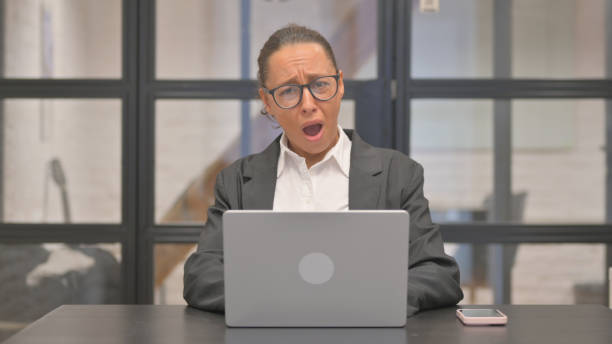 istock Shocked Mixed Race Business Woman Looking at Camera while Working on Laptop 2148513083