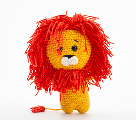 A crochet Amigurumi toy of a of cute stuffed Lion.