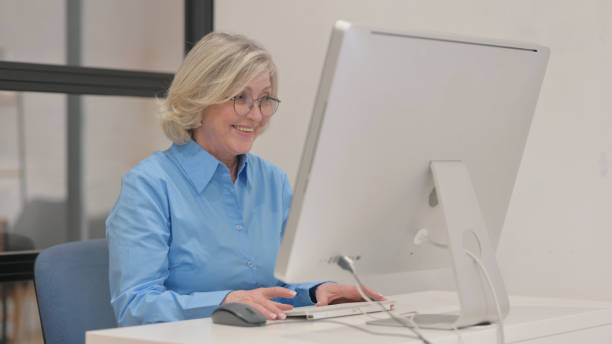 istock Video Chat by Old Businesswoman on Desktop Computer 2148514441